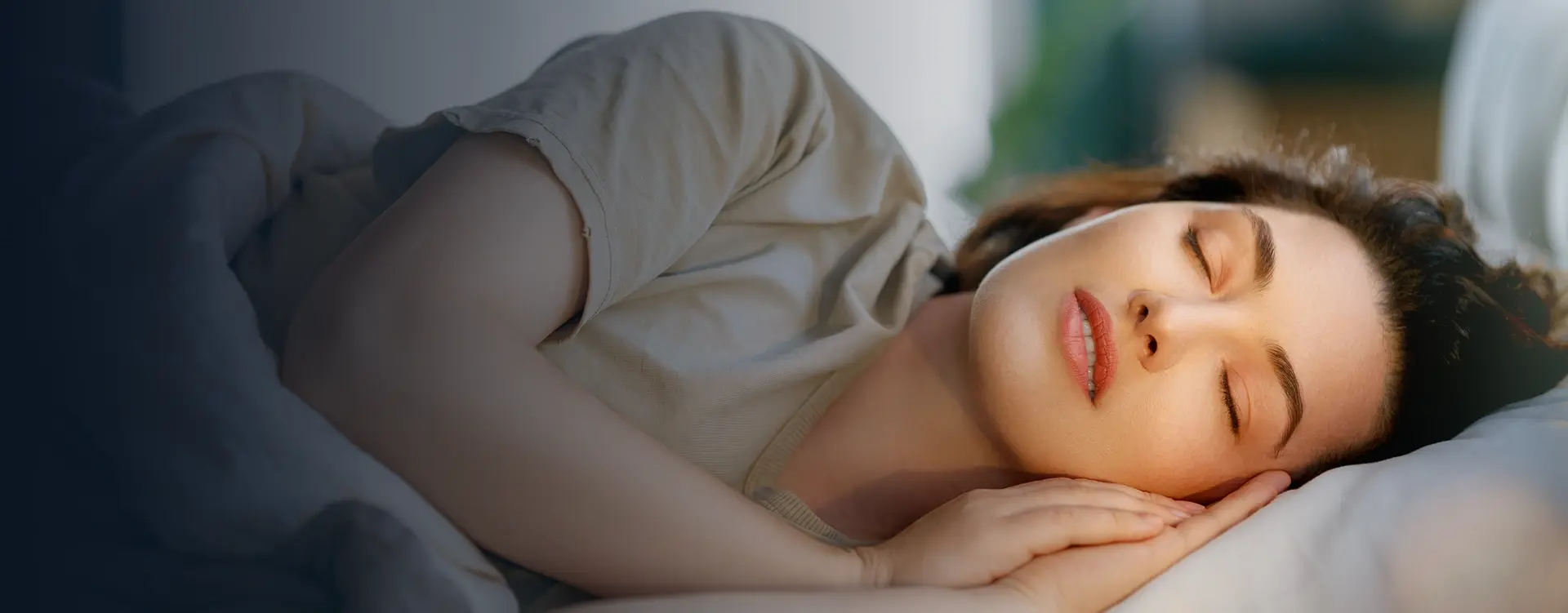 Woman peacefully sleeping, representing effective sleep apnea and snoring treatment solutions.